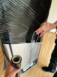 Snoer van koelkast in rekfolie wikkelen